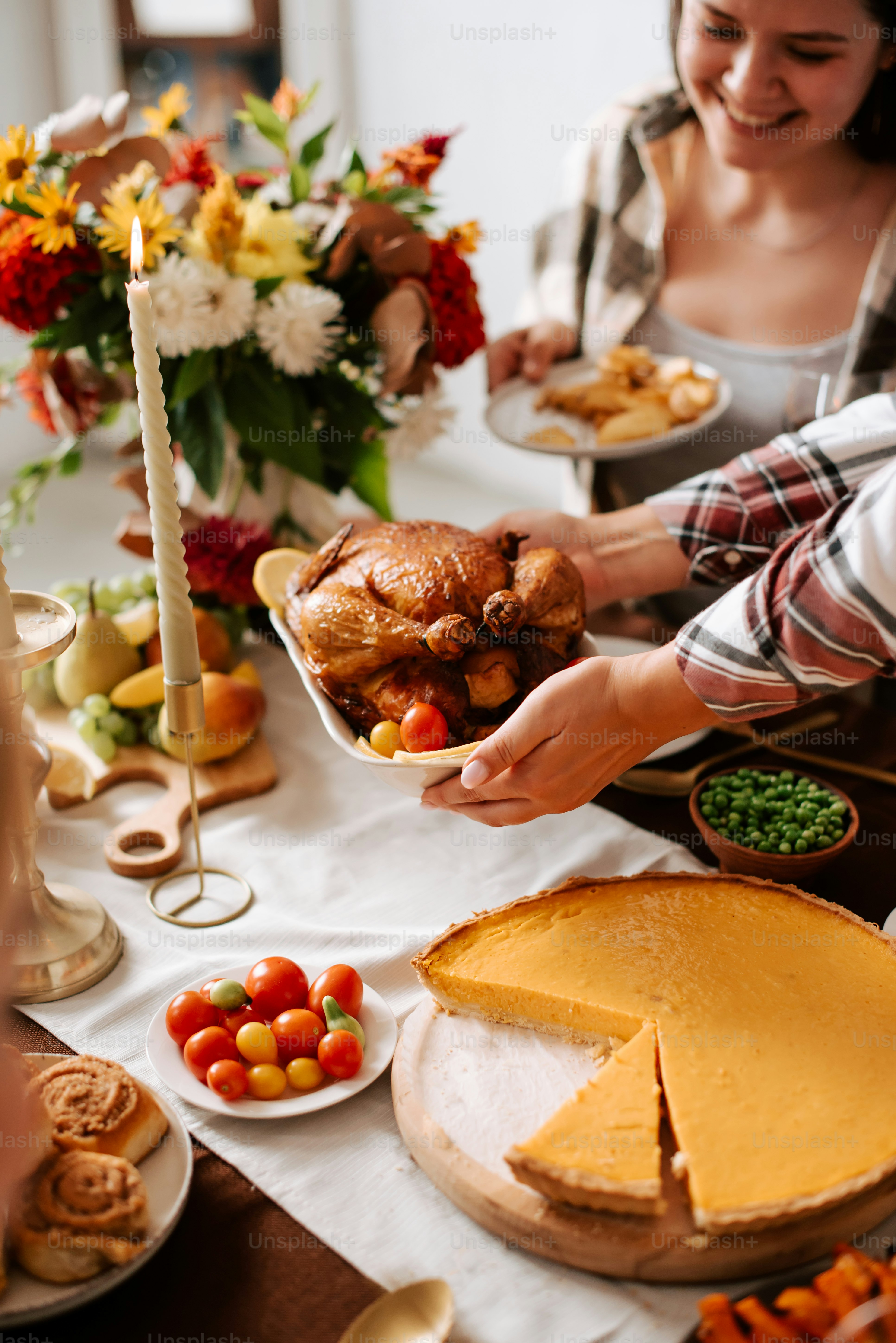 a woman holding a plate of food with a turkey on it