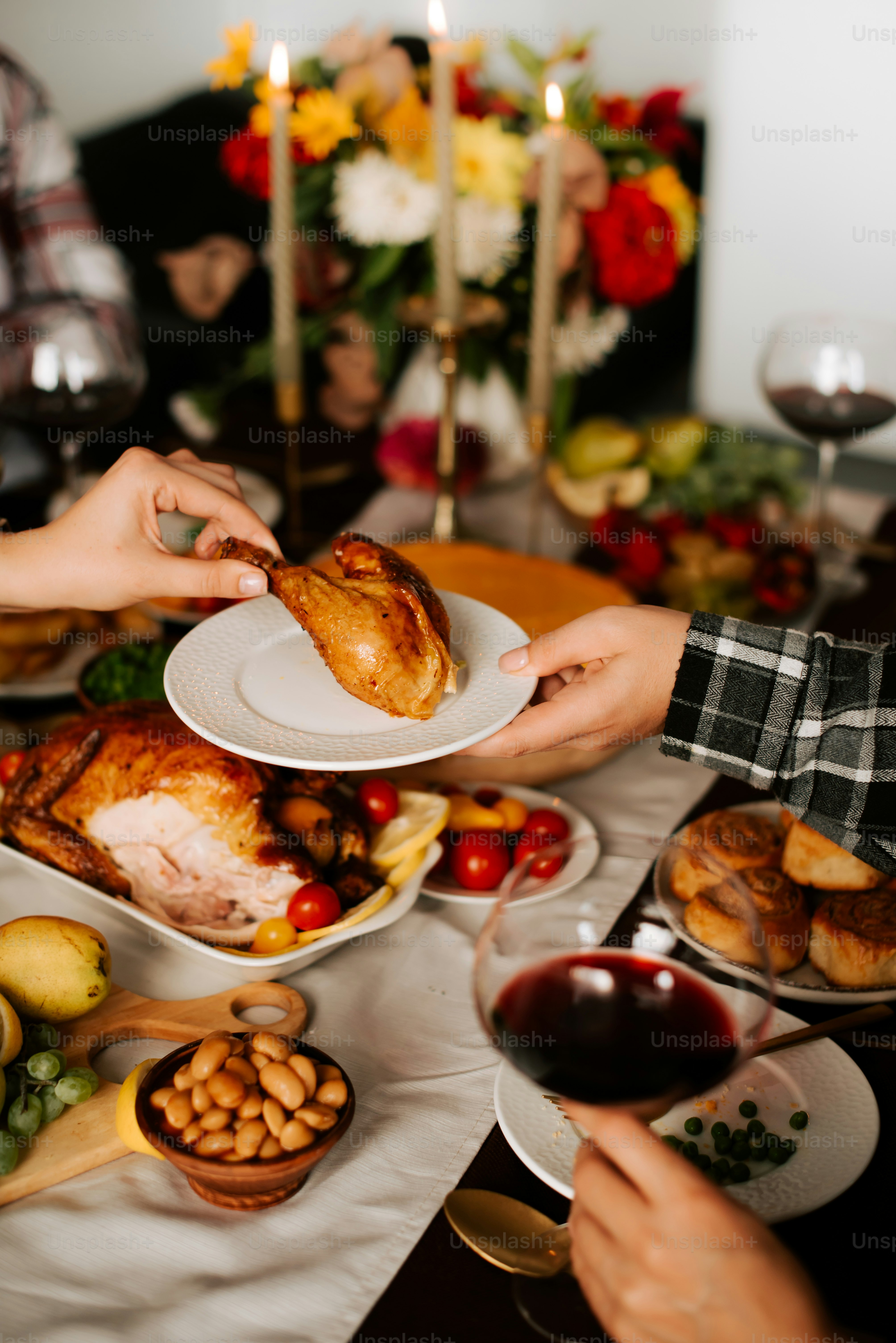 a group of people sitting around a table with plates of food