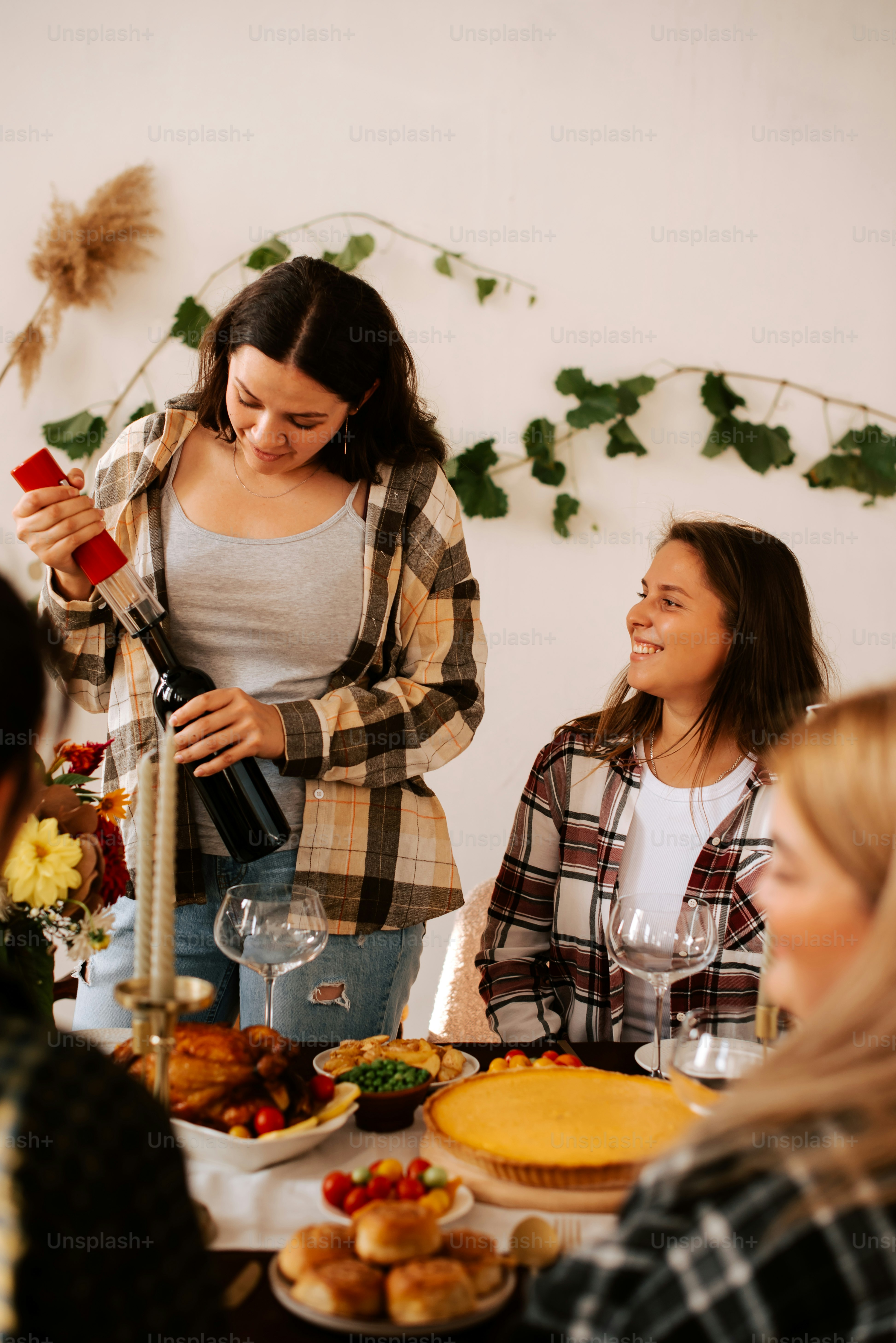 A group of people sitting around a table with food photo – Thanks ...