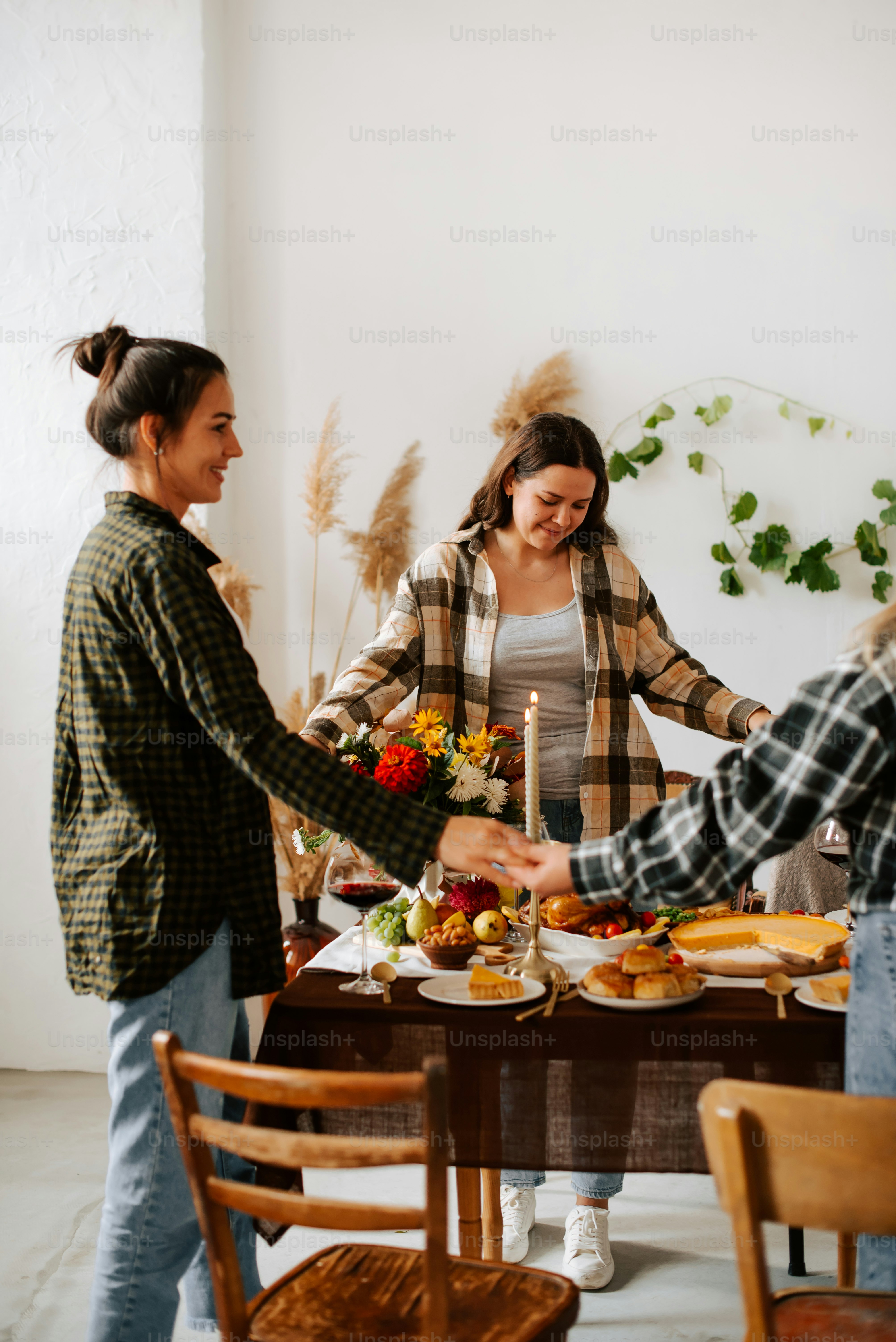 A group of people standing around a table with food photo – Thanks ...