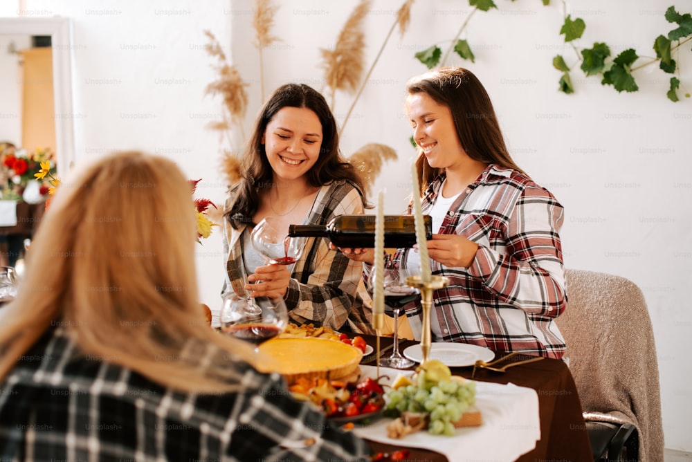 a group of women standing around a table with food