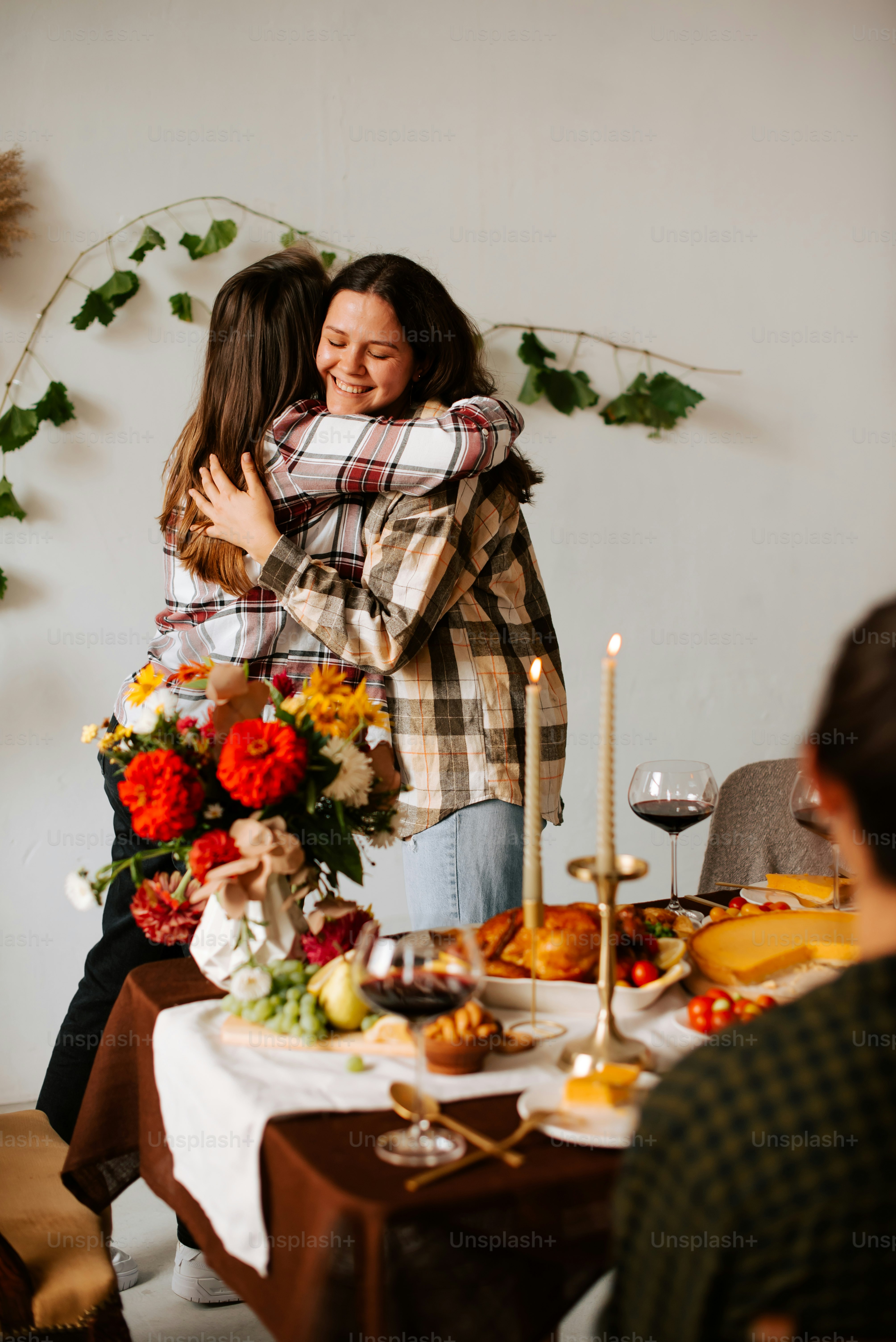 Two women hugging each other in front of a table photo – Thanksgiving ...