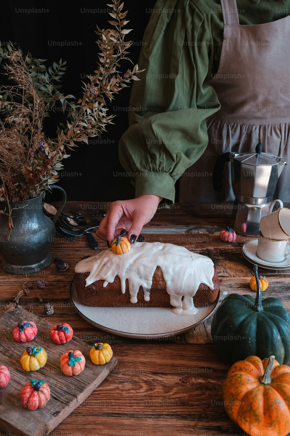 a person decorating a cake on a table