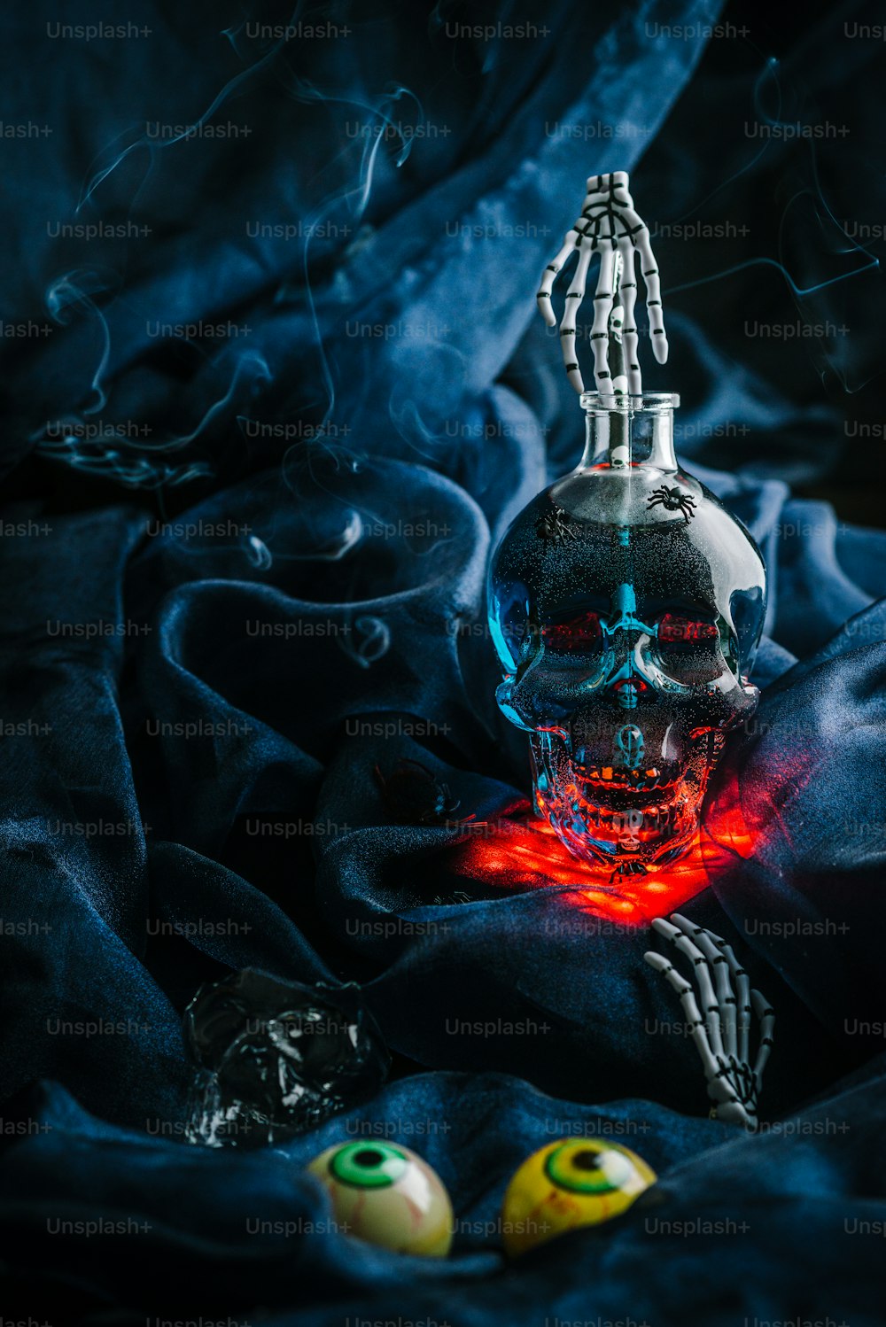 a glass bottle with a skeleton inside of it