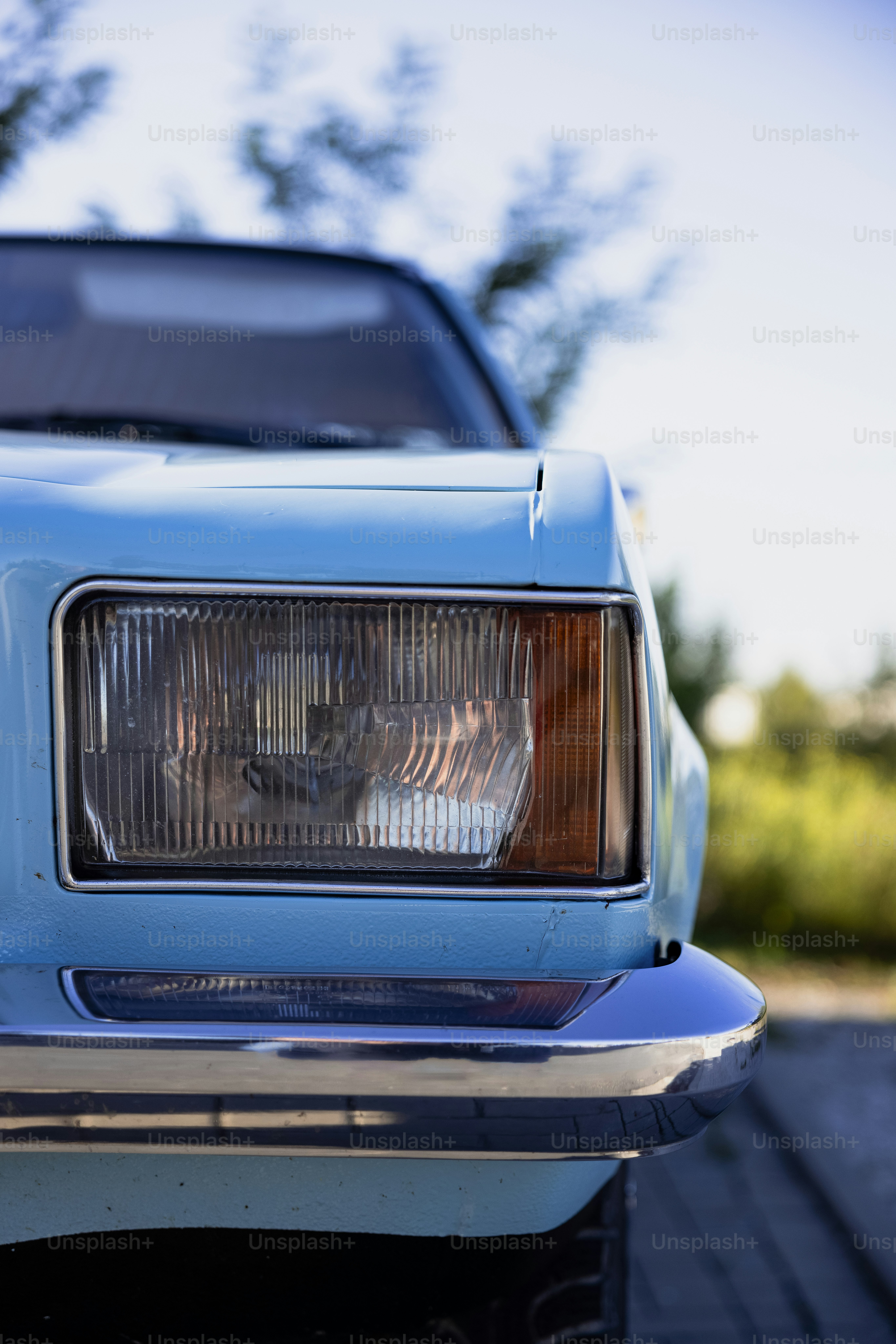 a close up of the front of a blue car