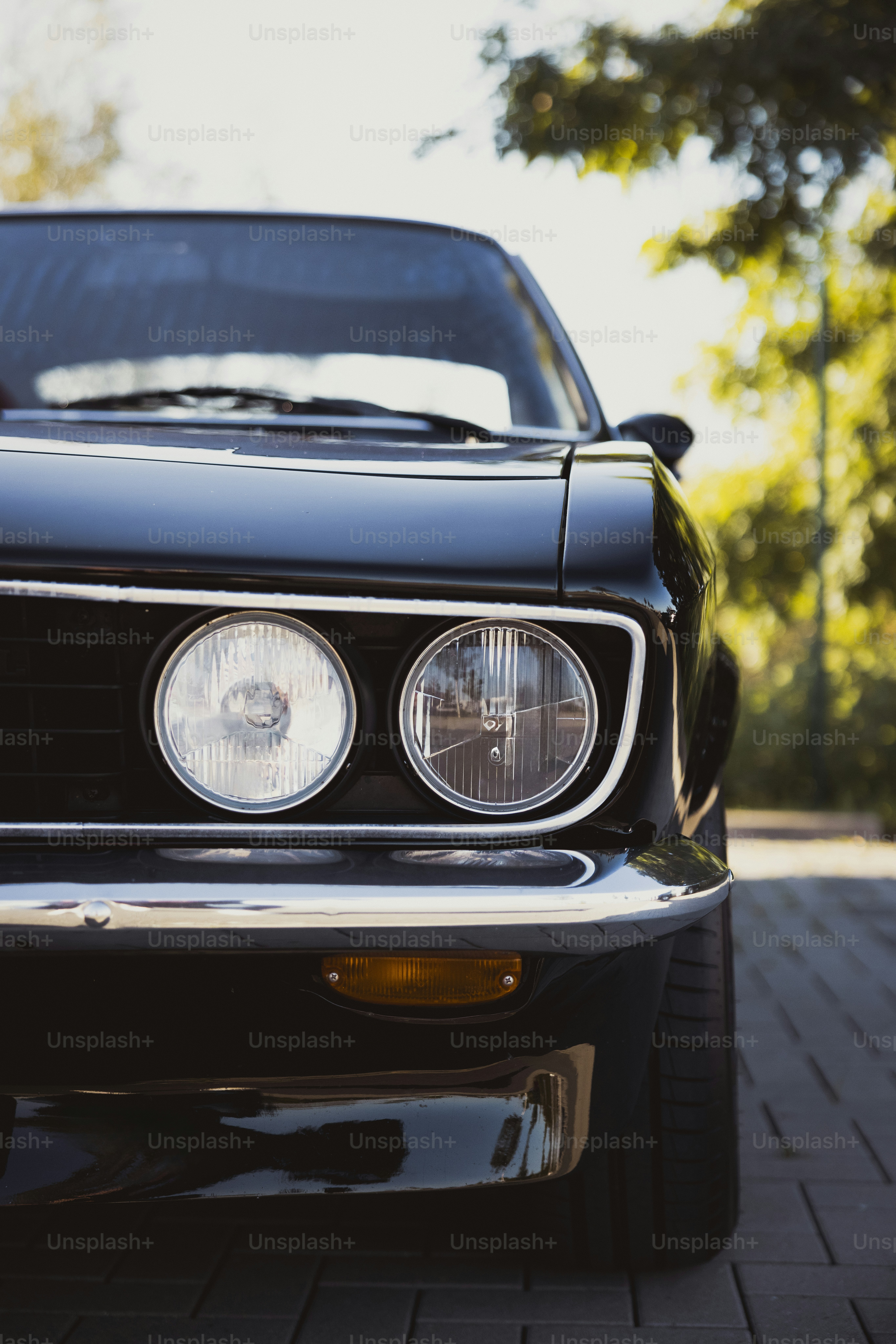 a close up of the front of a black sports car