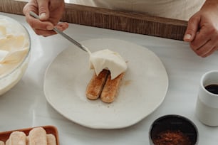 a person cutting a piece of cake on a plate
