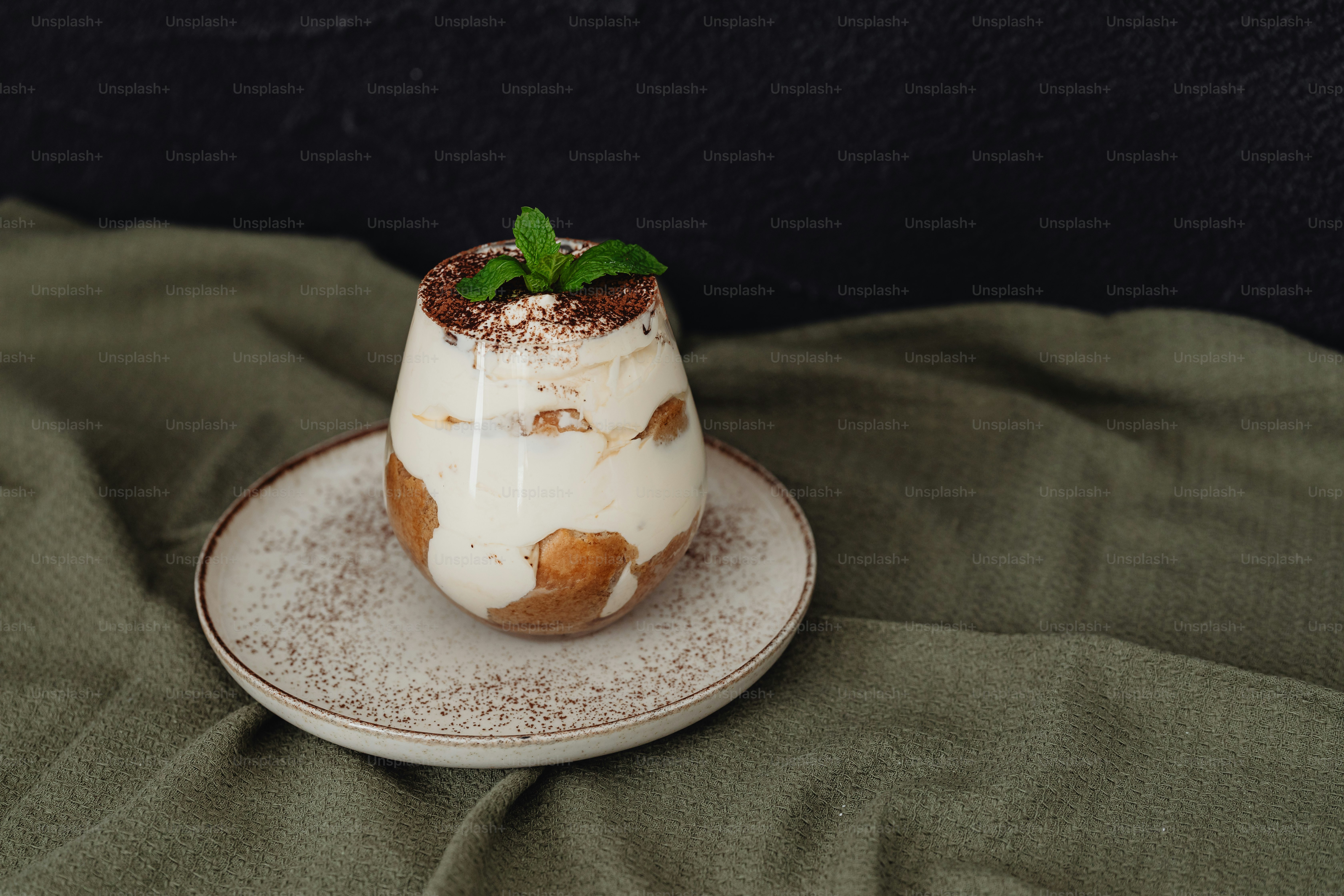 a dessert is sitting on a plate on a bed