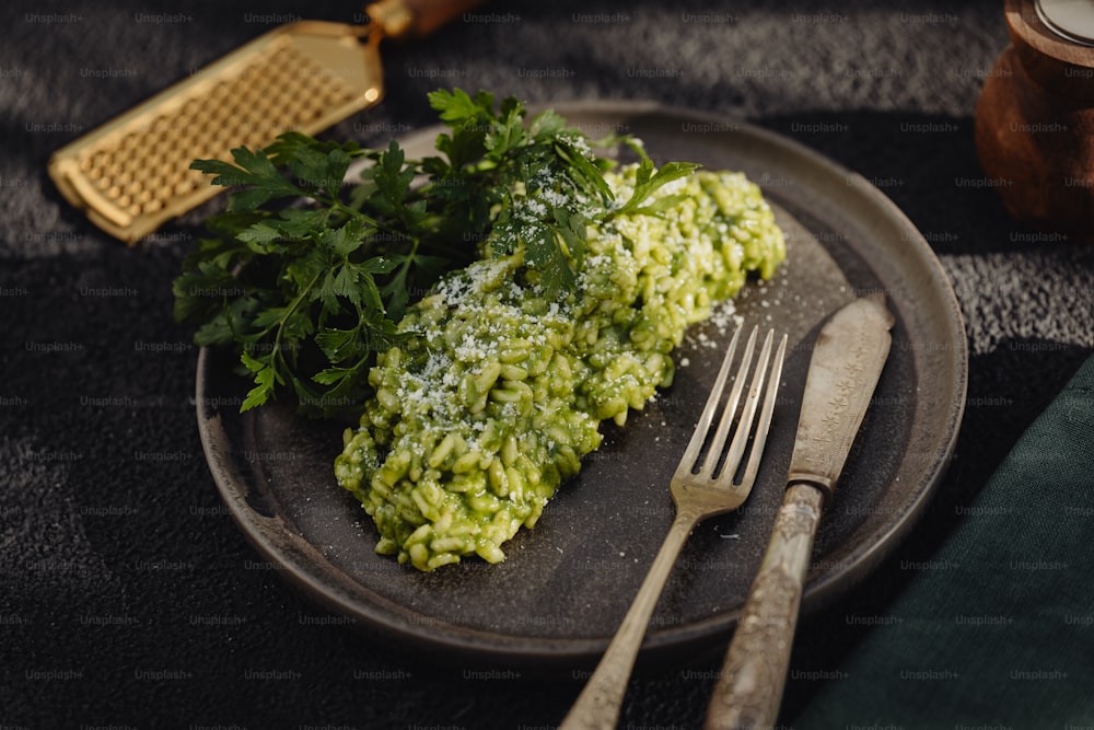 a plate topped with rice and parsley next to a fork