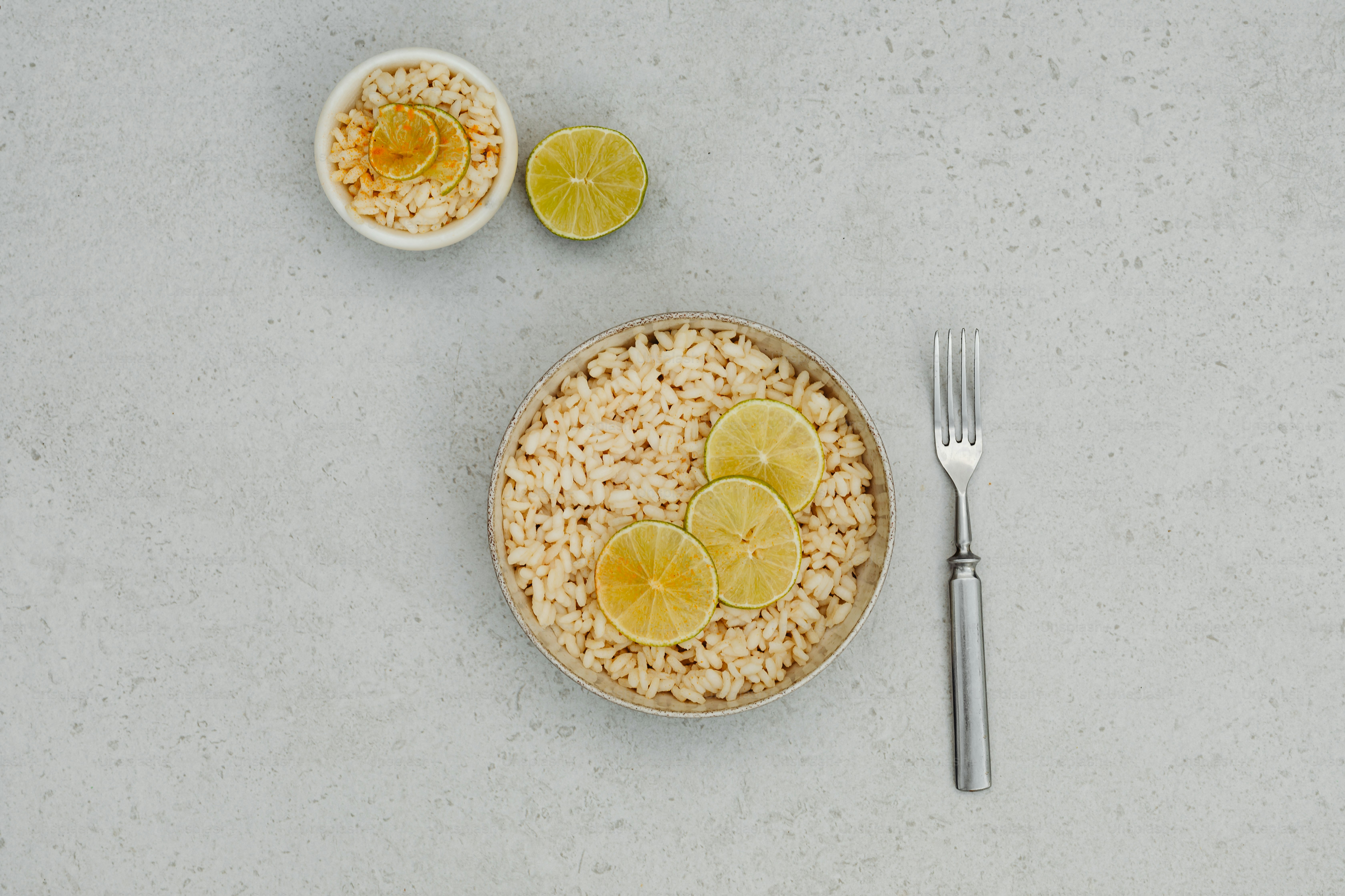A plate of rice with limes and a fork photo – Risotto Image on Unsplash