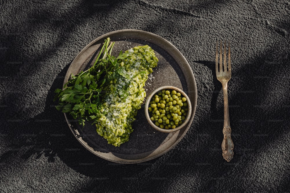 a plate of food with peas and a fork