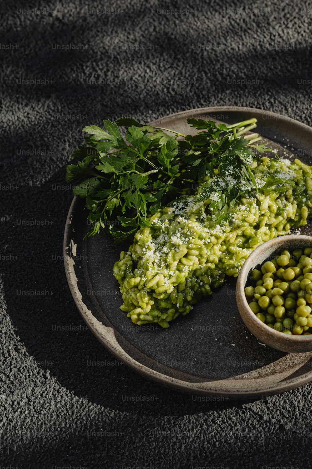 a plate of food with peas and parsley