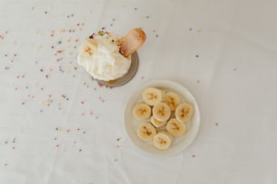 a plate of bananas and a cupcake on a table