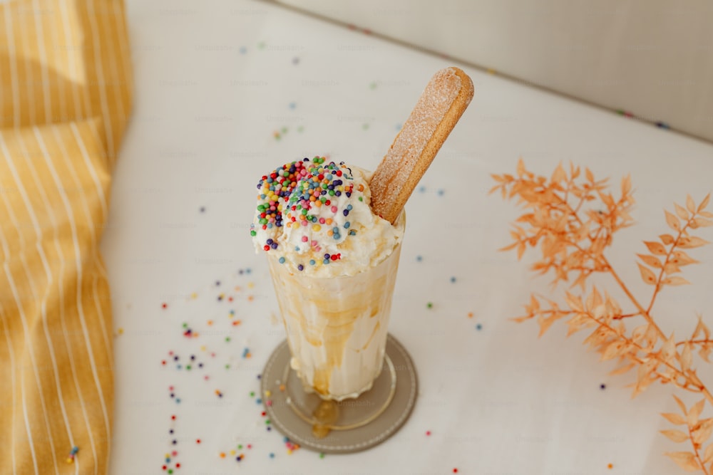 an ice cream sundae with sprinkles on a table