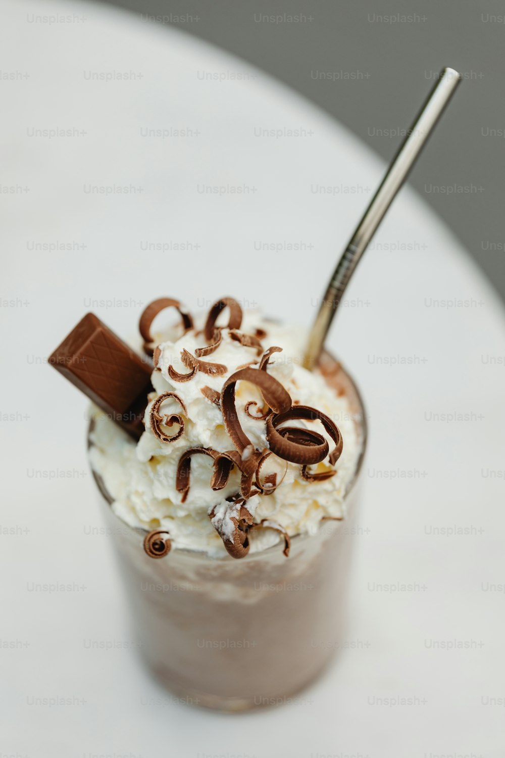 a cup of ice cream with chocolate and whipped cream