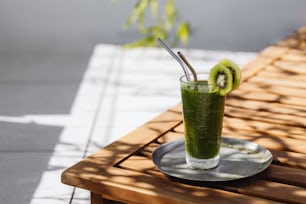 a green smoothie with kiwi slices on a plate