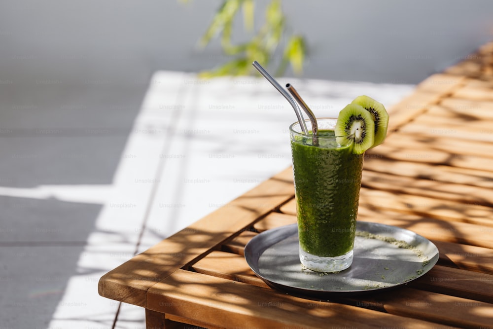 a green smoothie with kiwi slices on a plate