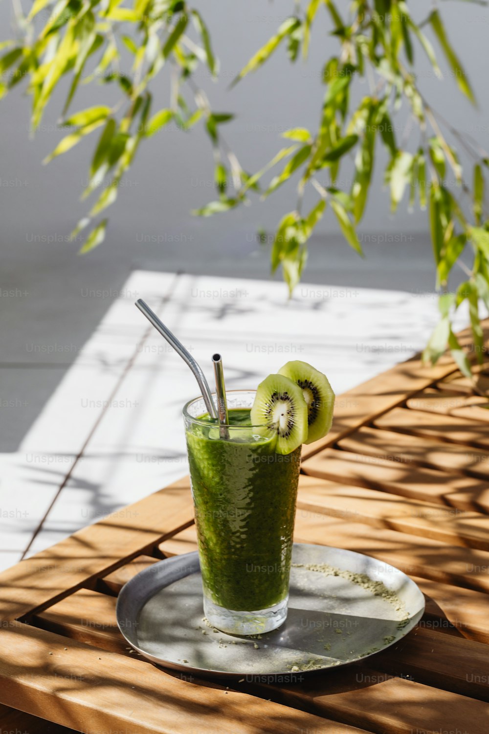 a green smoothie with kiwi slices on a plate