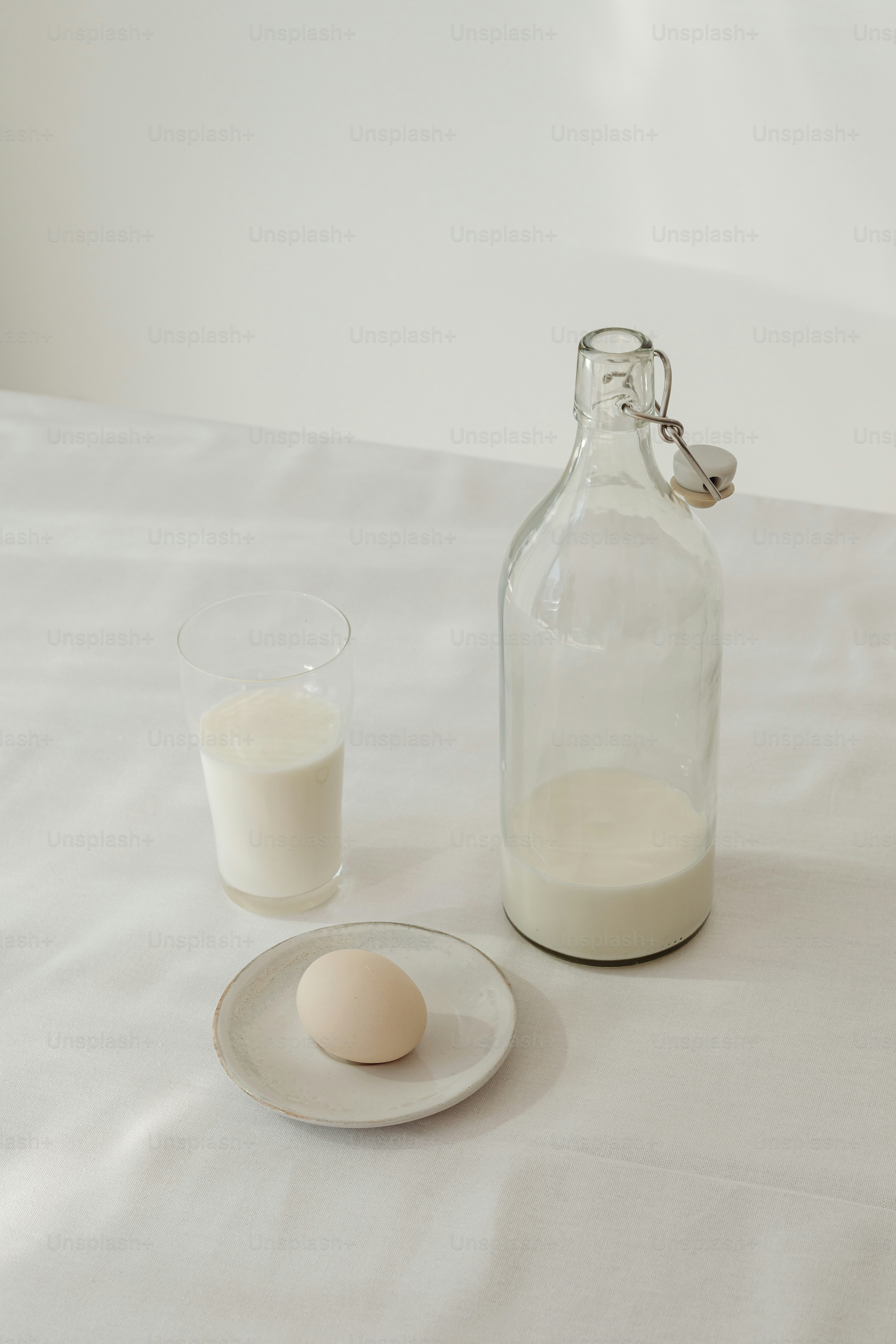 a bottle of milk next to a glass of milk
