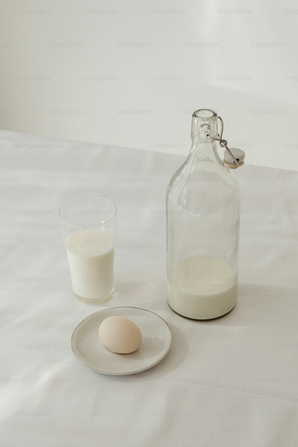 a bottle of milk next to a glass of milk