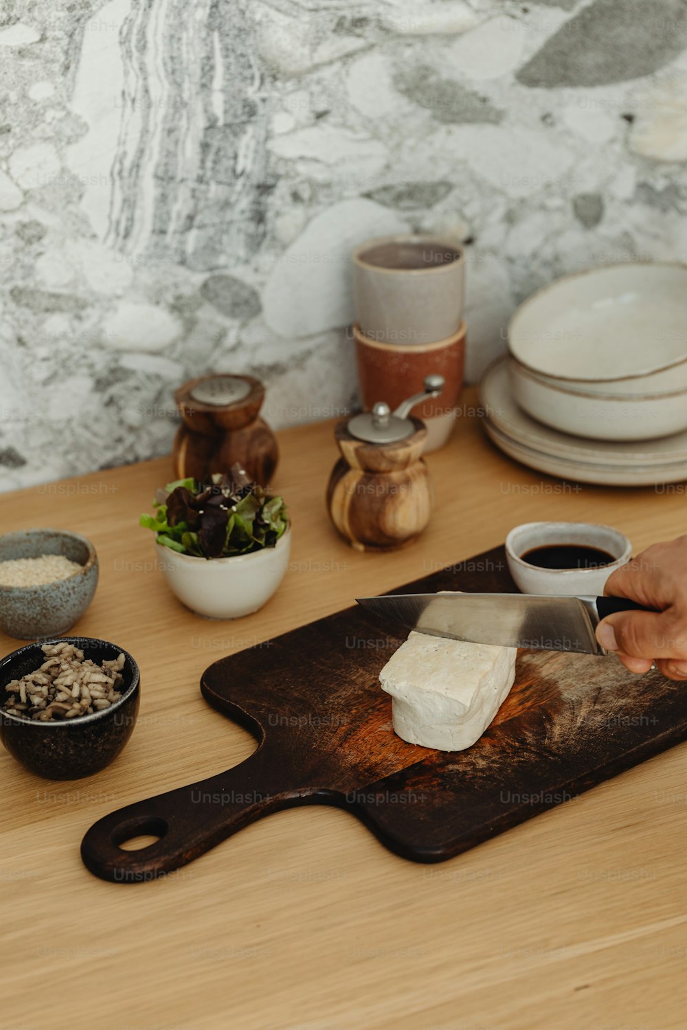 a person cutting up food on a cutting board