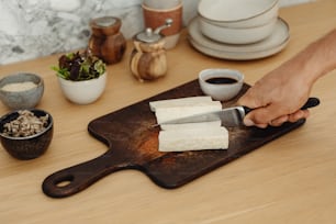 a person cutting food on a cutting board