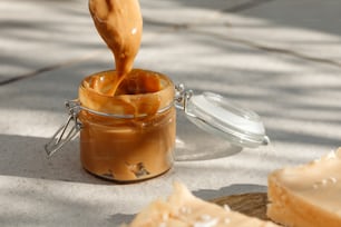 a jar of peanut butter being poured into it