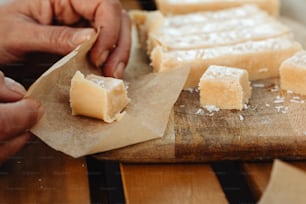 a close up of a person cutting food on a cutting board