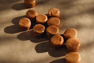 a pile of chocolate covered donuts sitting on top of a table