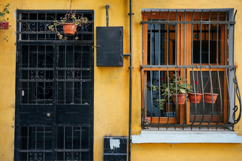 a yellow building with a black door and window