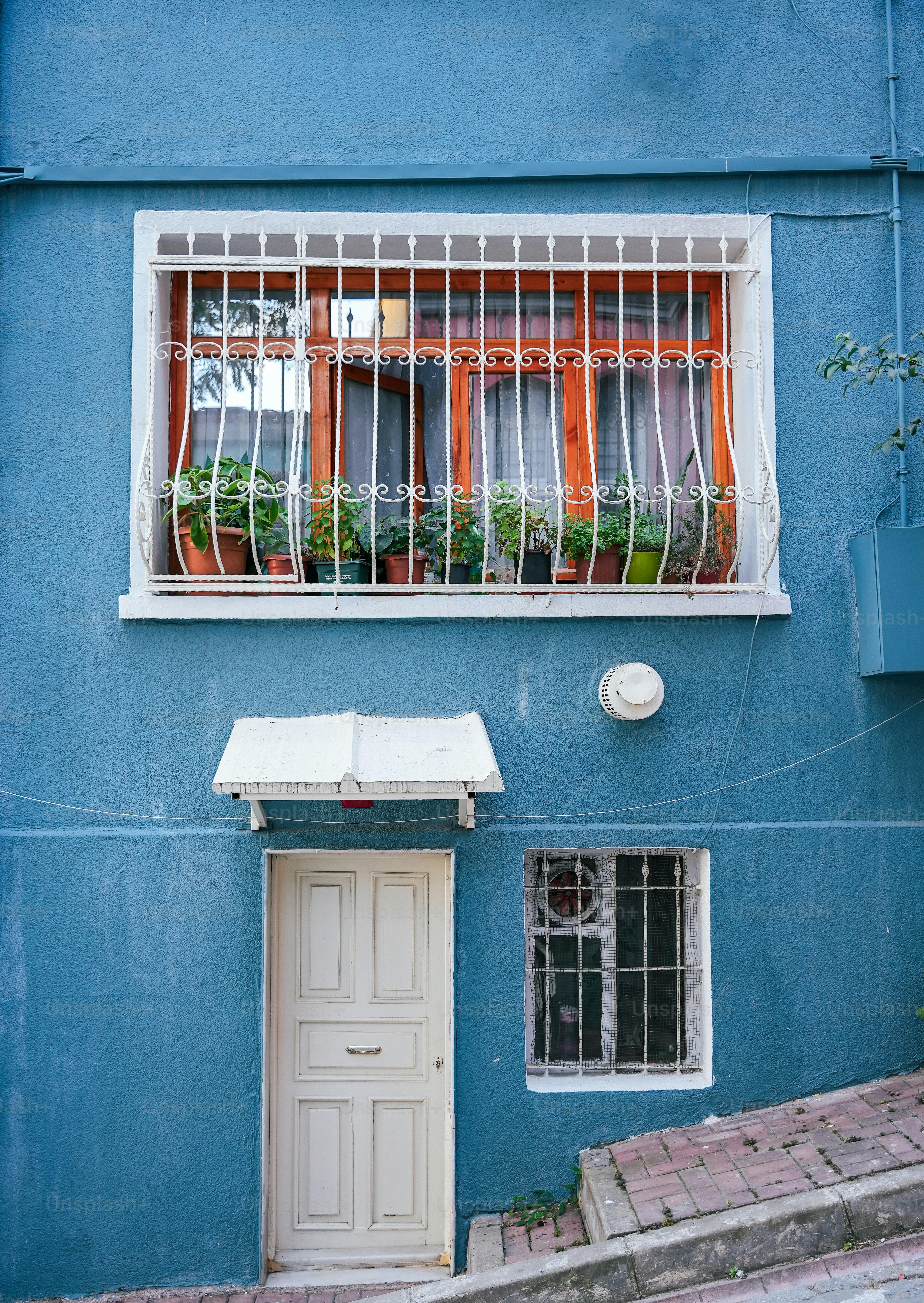 a blue building with a white door and window