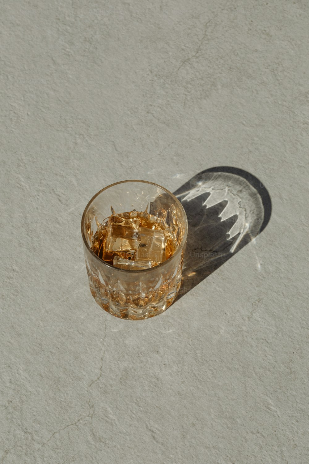 a glass filled with ice sitting on top of a table