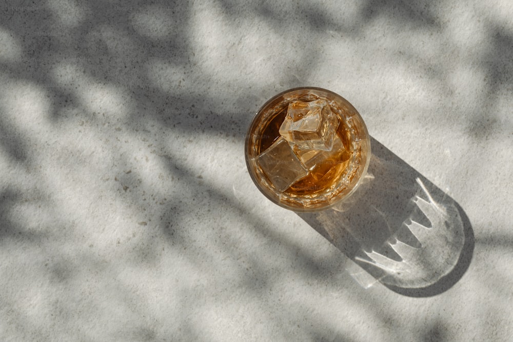 a glass of liquid sitting on top of a table