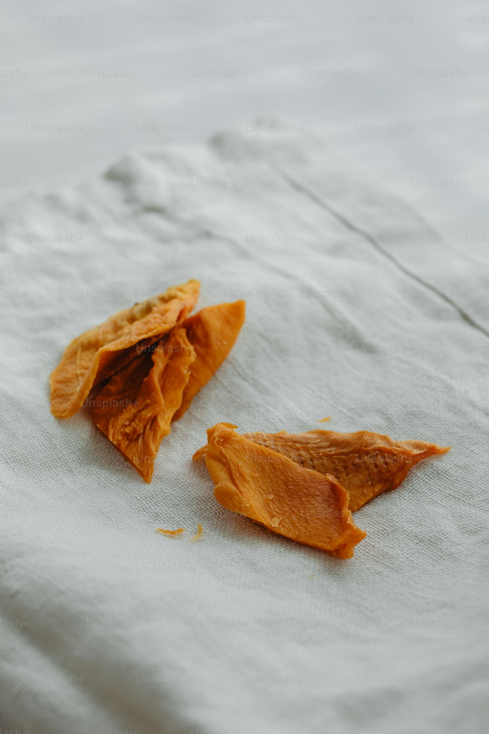 a couple of pieces of food sitting on top of a white cloth