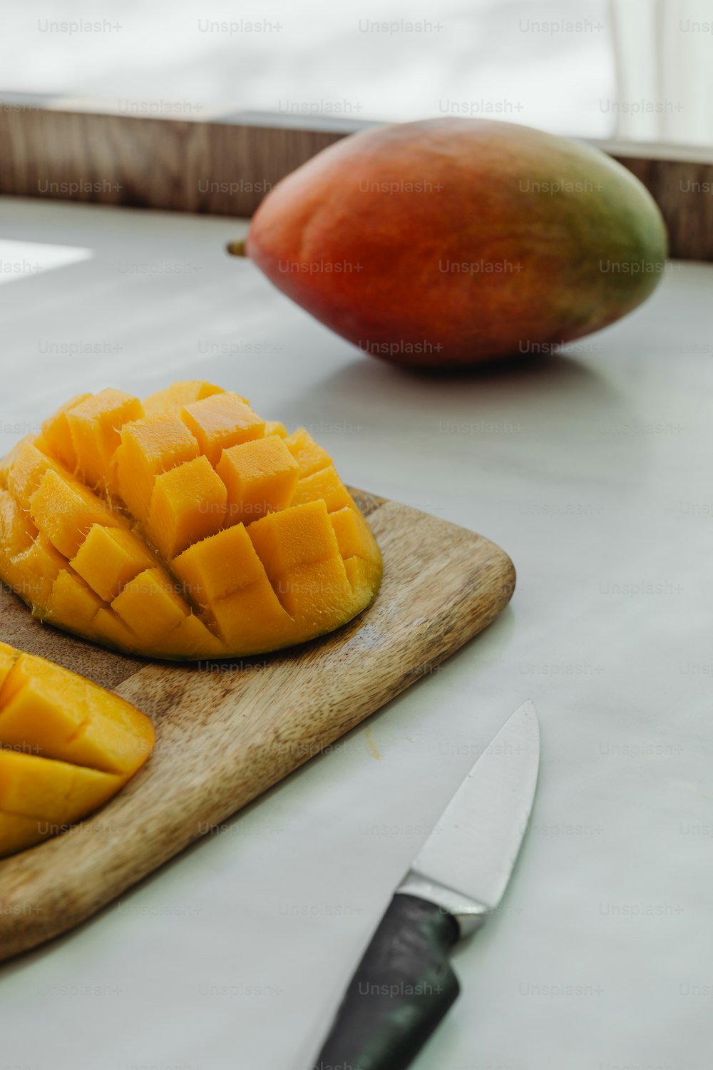 a mango and a mango on a cutting board