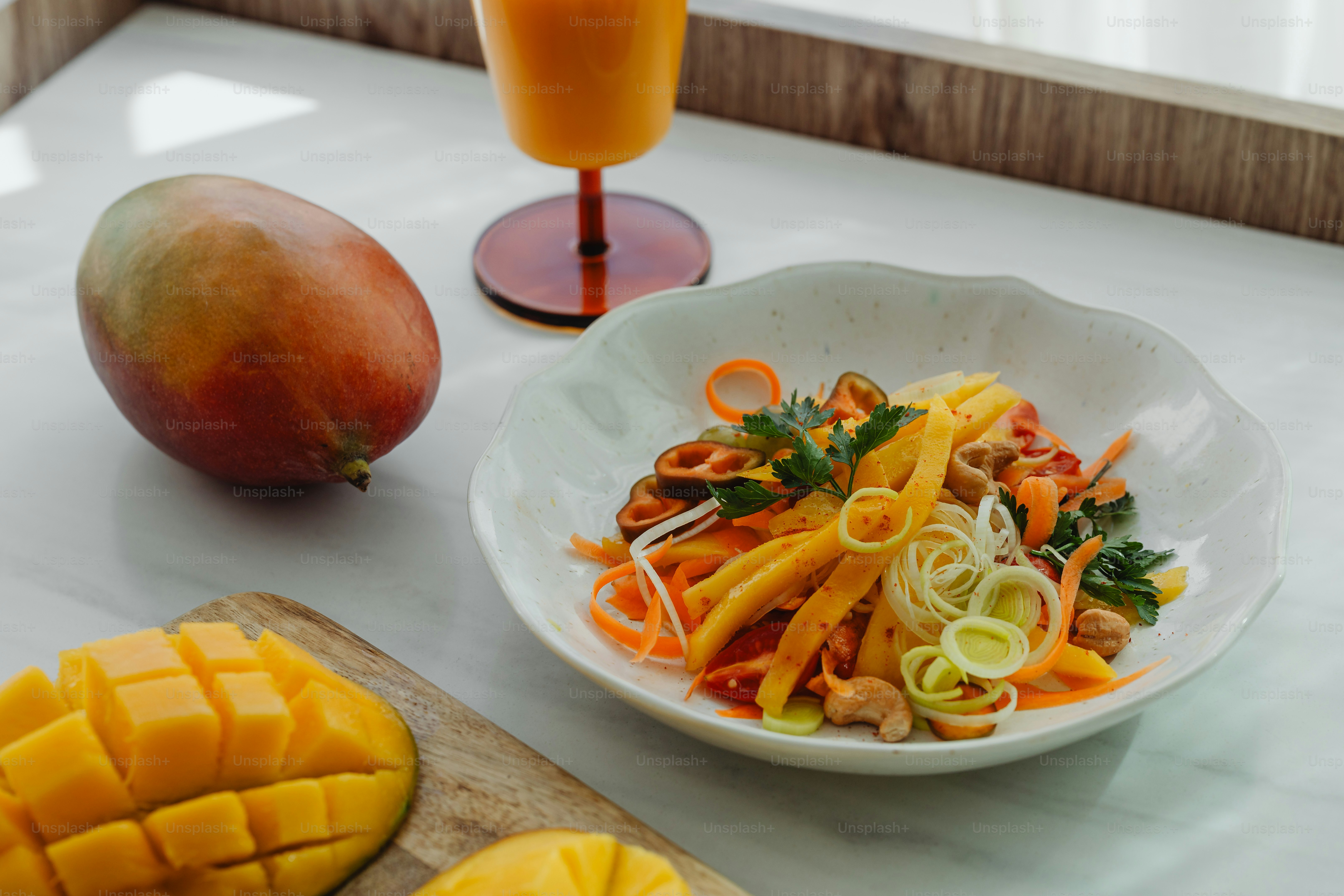 uma tigela de comida em uma mesa ao lado de um copo de suco de laranja