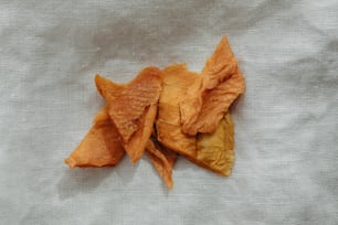 a pile of potato chips sitting on top of a white cloth