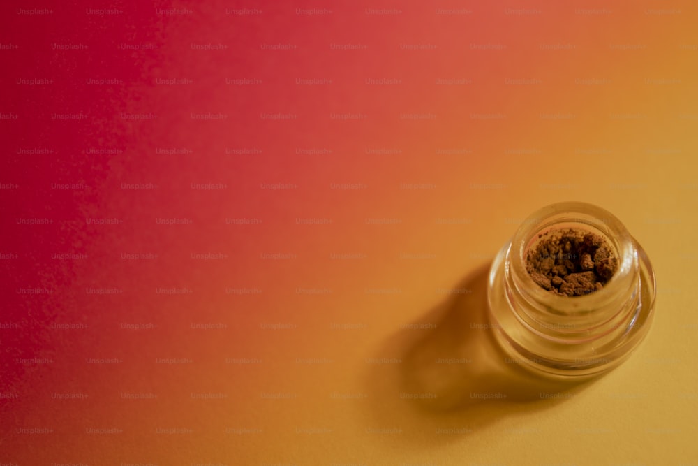 a small glass jar filled with a brown substance