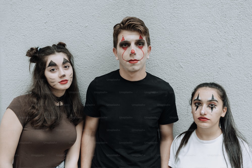 a group of people with painted faces standing next to each other