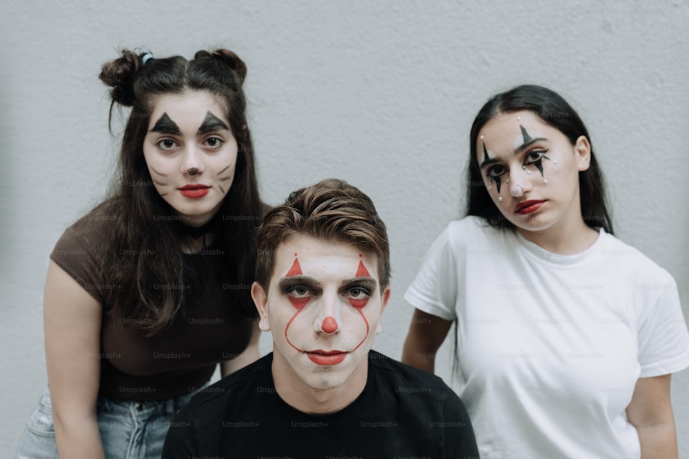 a group of people with clown makeup on their faces