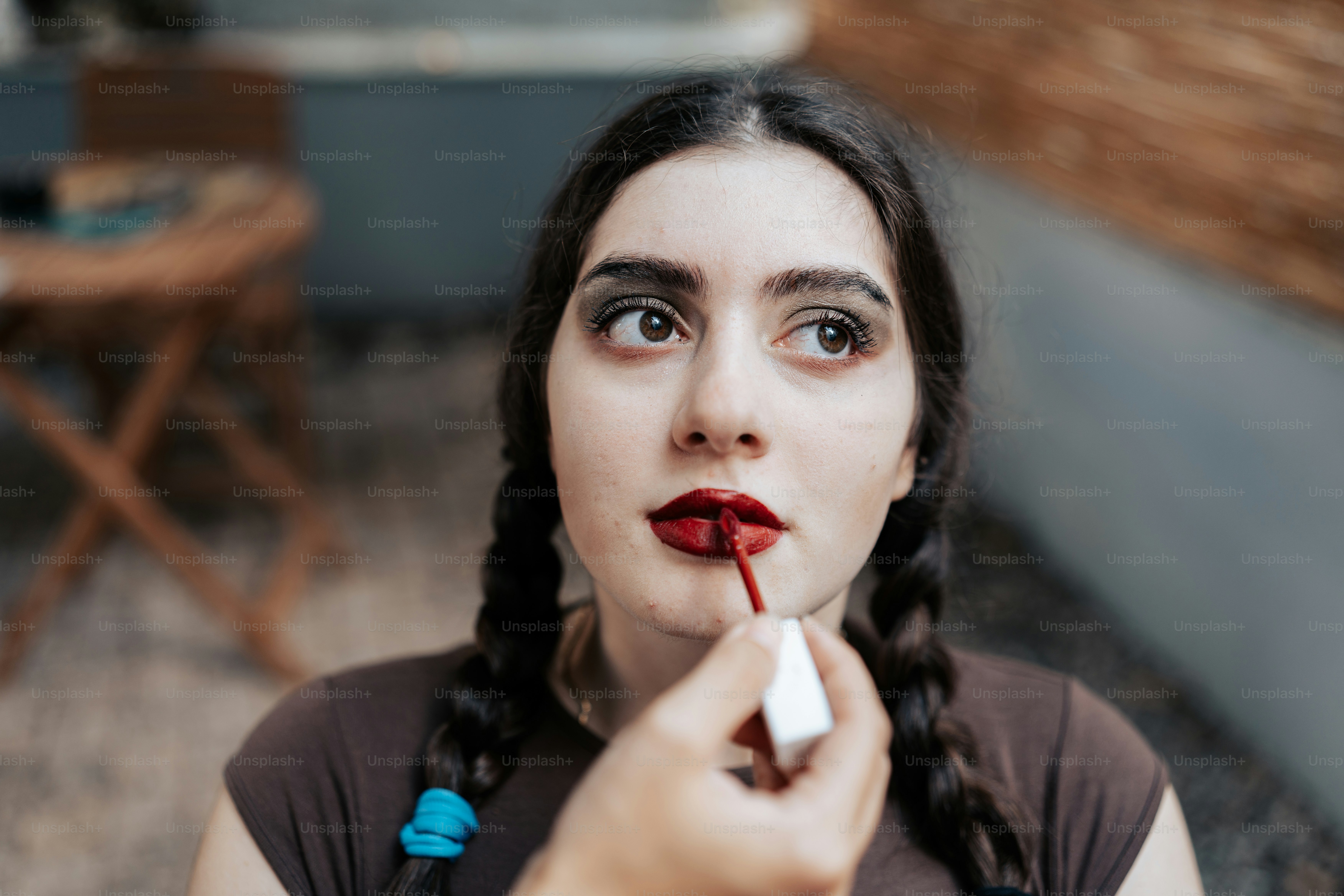 A woman with long black hair and a red lipstick on her lips photo ...