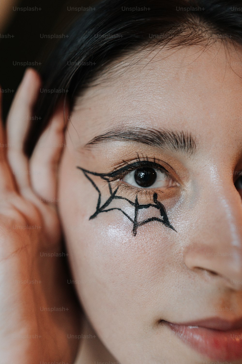 a woman with a spider web painted on her face