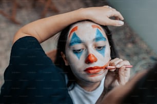 a woman with a clown face painted on her face