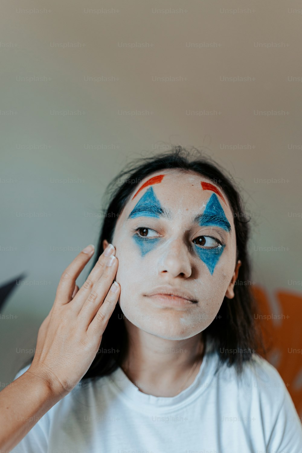 a woman with blue and red painted on her face