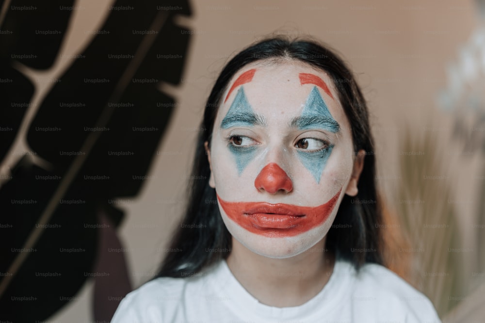 a woman with a clown makeup on her face