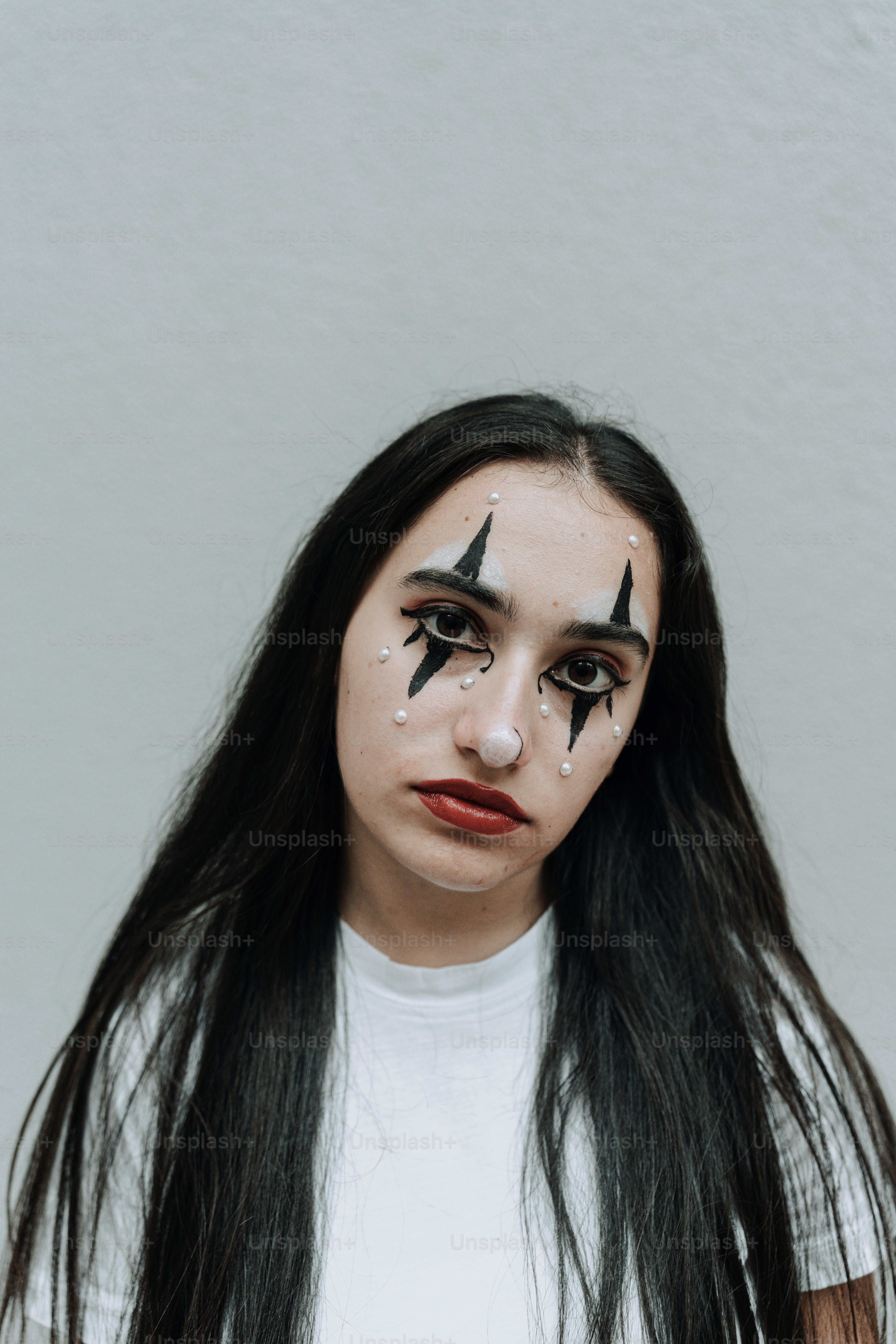 a woman with makeup on her face and nose