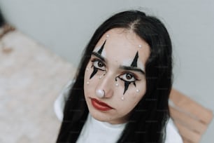 a woman with black hair and white makeup