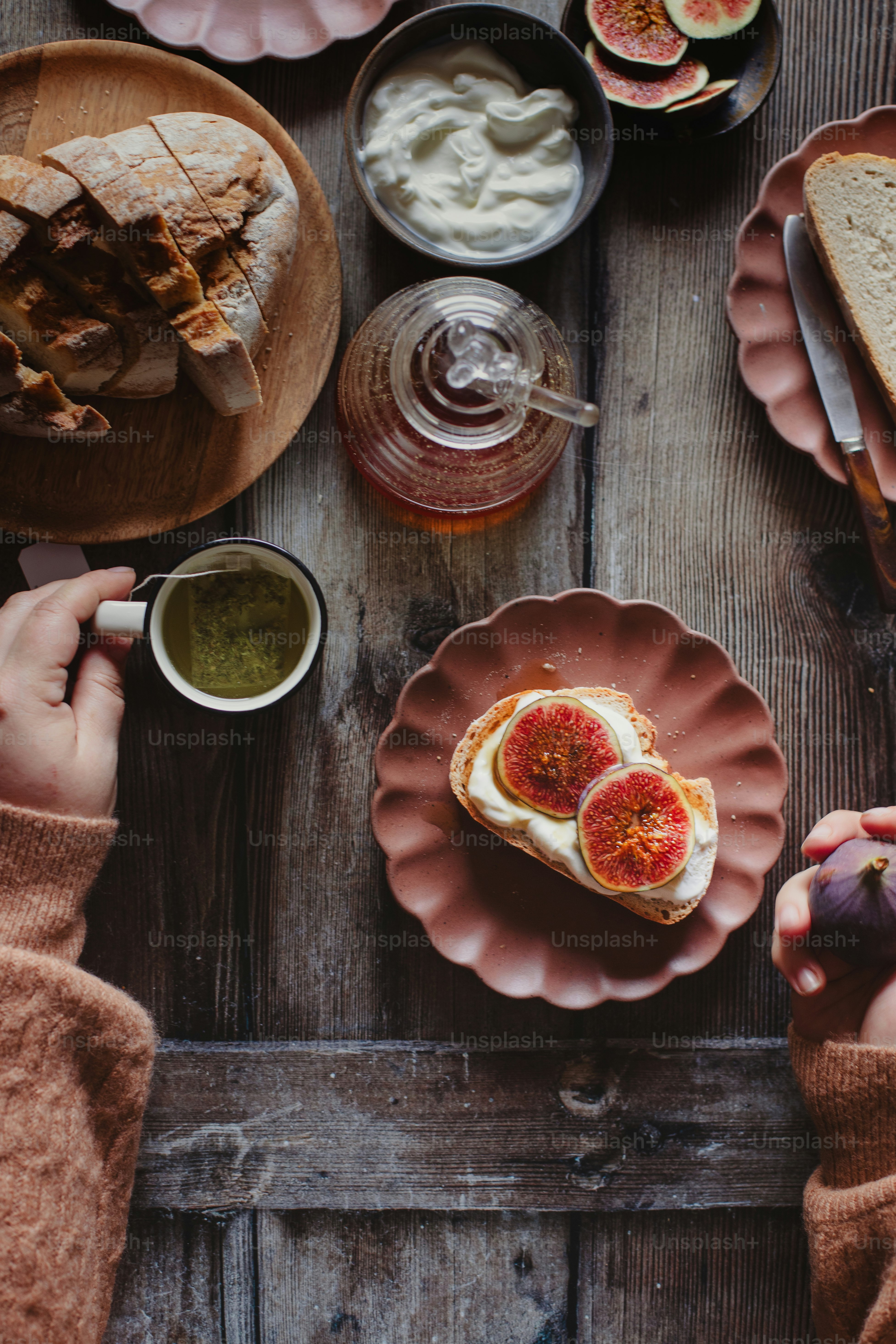 a wooden table topped with plates of food