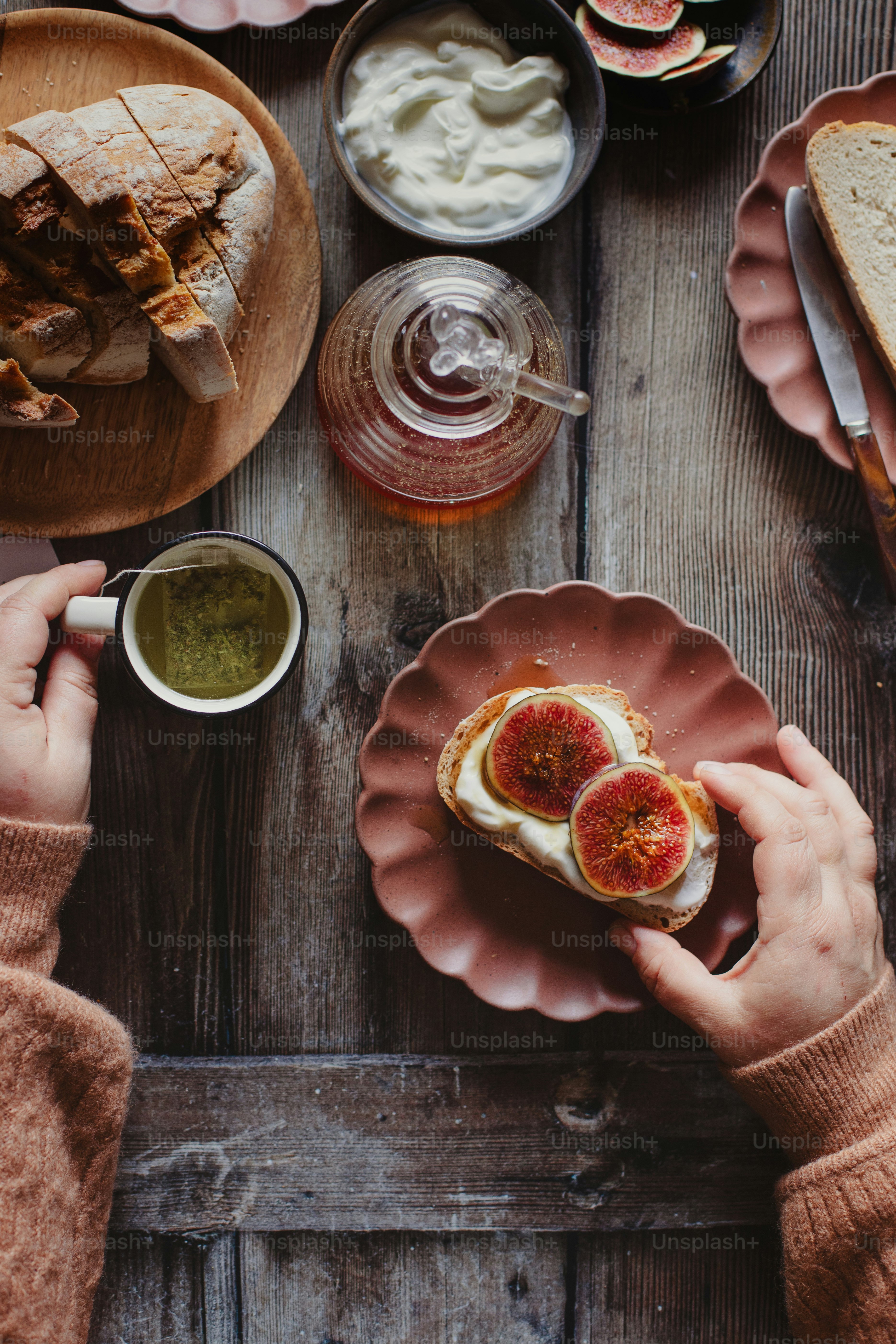 a person holding a plate with a sandwich on it