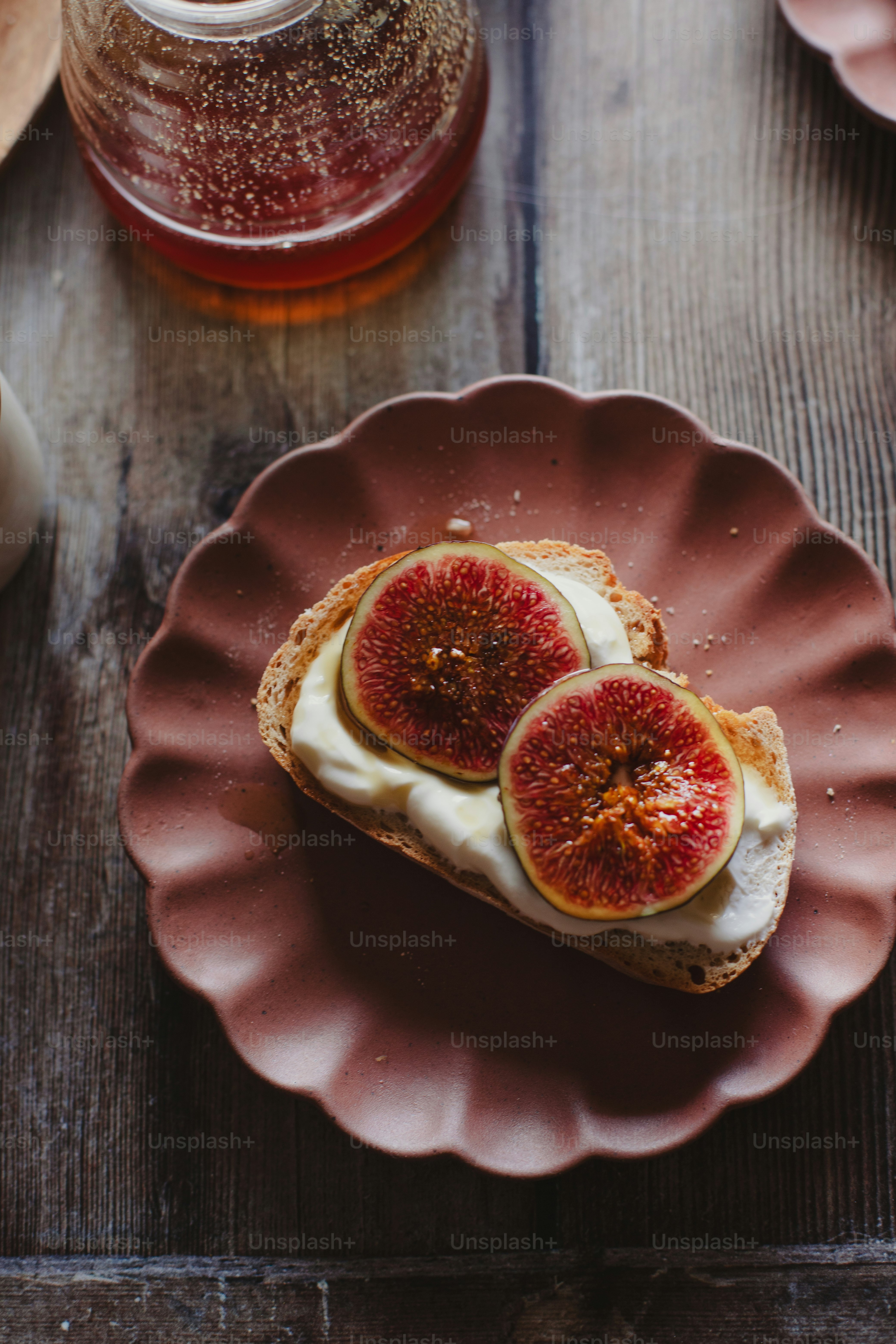 a piece of toast with cream cheese and figs on it
